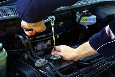 A mechanic working on a car